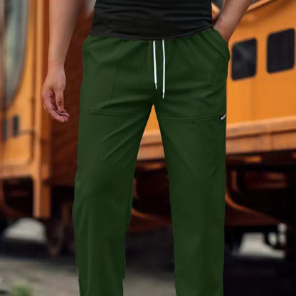 Men's light grey polyester trousers with an elasticated waistband laid flat