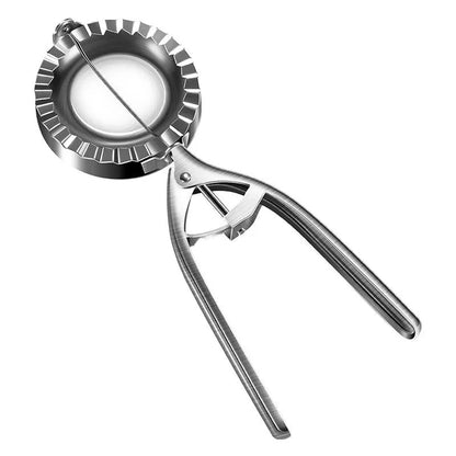 Silver stainless steel manual dumpling press tool on a wooden kitchen surface