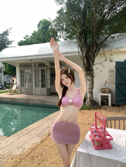 Pink and black polyester three-piece bikini swimsuit on a mannequin