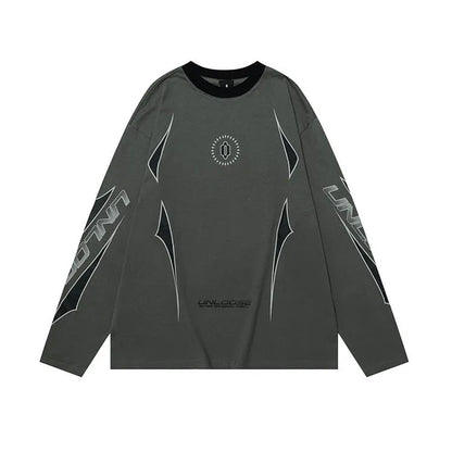Woman wearing a grey khaki loose drop shoulder sweatshirt with a printed letter design.