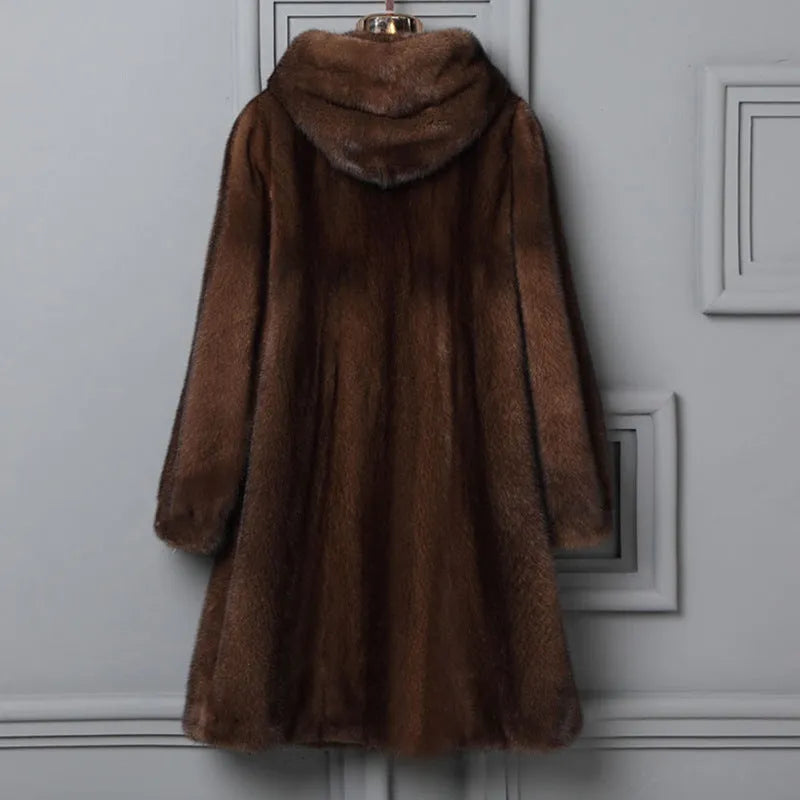 Woman wearing a long black faux fur hooded coat in a street fashion style.