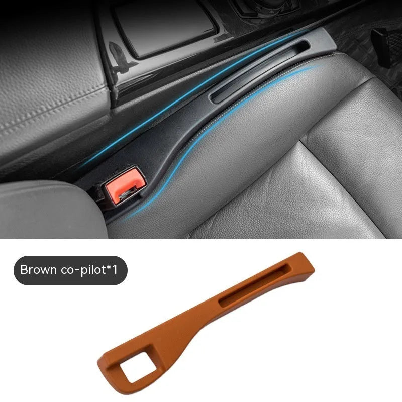 Black car seat gap storage box organiser with compartments and carrying handle between vehicle seats
