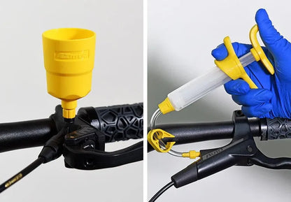 Bicycle hydraulic disc brake oil bleed kit tools with syringes, adapters, and wrenches on a workbench