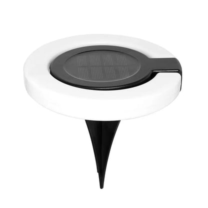 Solar-powered waterproof underground garden light showing its low-profile design and solar panel.