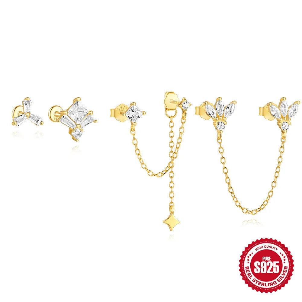Close-up of golden-toned sterling silver double stud earrings with a delicate chain and sparkling zircon stone.