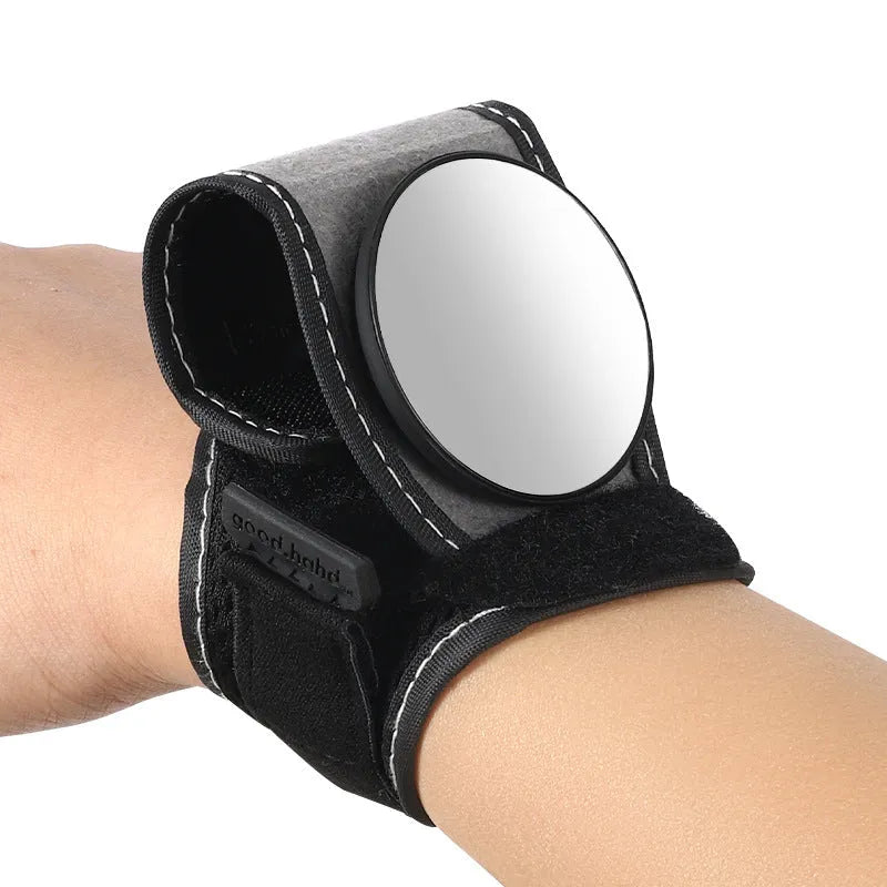 Black nylon bicycle rear-view mirror mounted on a cyclist's wrist.