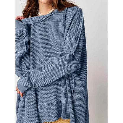 A cosy, oversized black hoodie with pockets, perfect for keeping warm during the autumn and winter seasons in the UK.