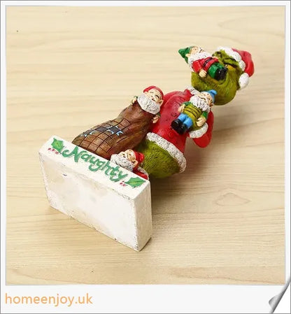 A resin garden statue depicting the Grinch sneakily enjoying a snack, surrounded by a group of jolly gnomes.