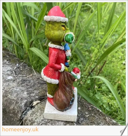A resin garden statue depicting the Grinch sneakily enjoying a snack, surrounded by a group of jolly gnomes.