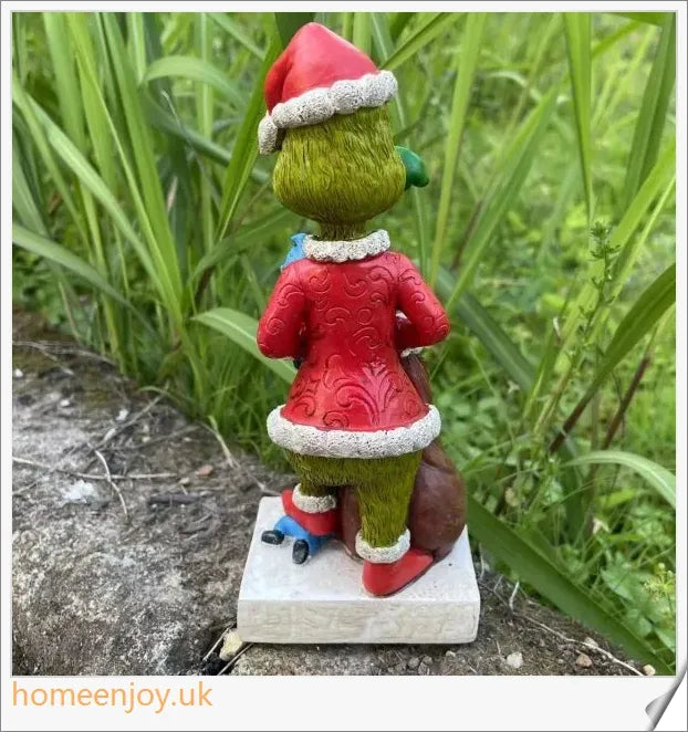 A resin garden statue depicting the Grinch sneakily enjoying a snack, surrounded by a group of jolly gnomes.