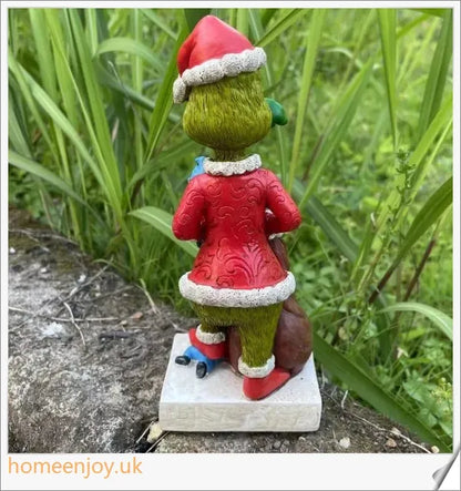A resin garden statue depicting the Grinch sneakily enjoying a snack, surrounded by a group of jolly gnomes.