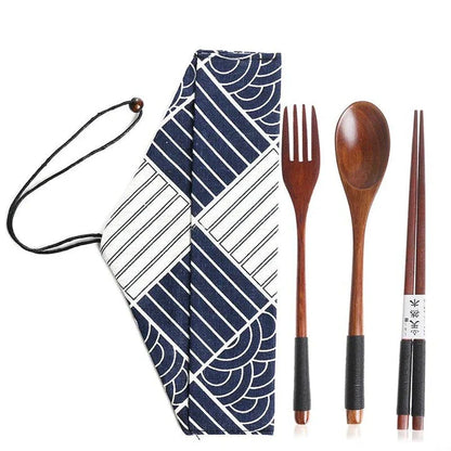 A portable wooden cutlery set with a coordinating cloth bag, perfect for outdoor dining and travel.