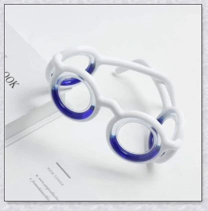 A pair of black motion sickness glasses with a blue liquid-filled ring to create an artificial horizon and relieve nausea, dizziness, and vertigo during travel.