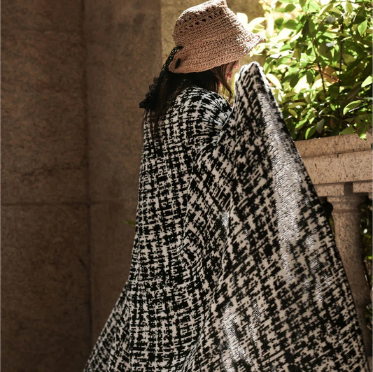 Cosy wearable wool blend travel blanket with timeless black and white striped pattern
