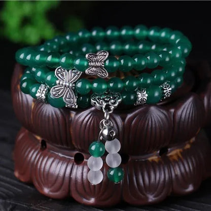 Close-up of a green agate multi-layer chain bracelet with three strands of 6mm beads.