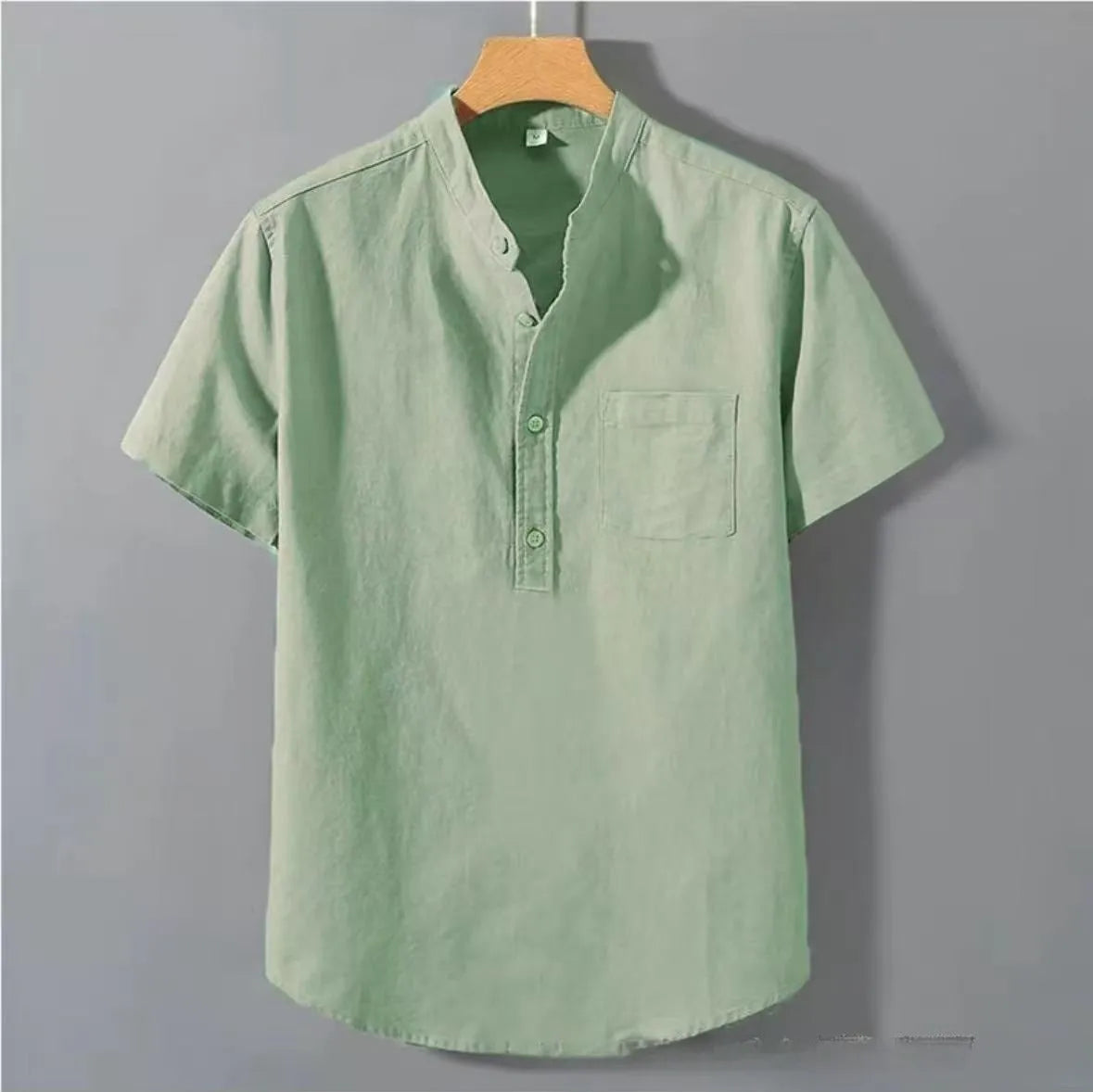 Men's casual beige linen-cotton shirt with stand collar and short sleeves on a hanger