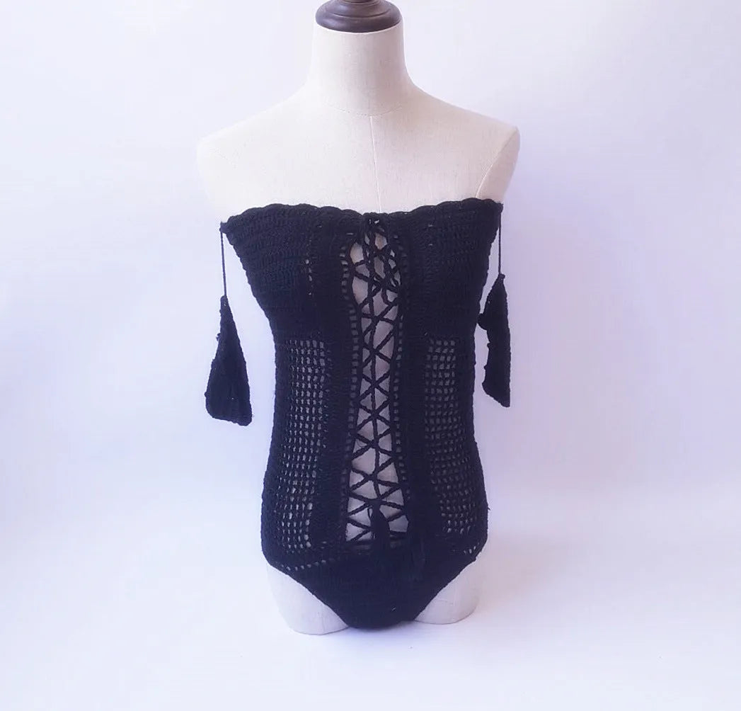 Off-shoulder one-piece swimsuit in aqua green on a mannequin, showing European/American cut and secure neckline.