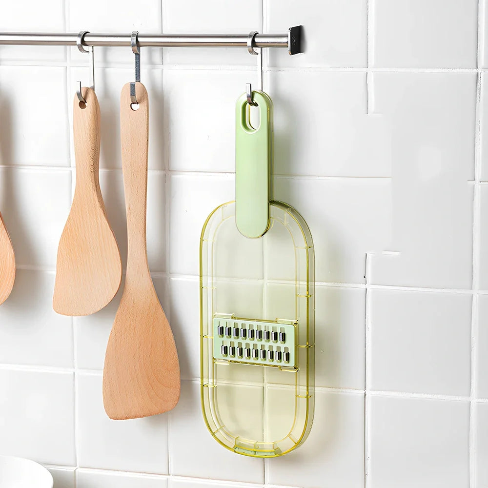 Shredded vegetable slicer with stainless steel blades on green cutting board