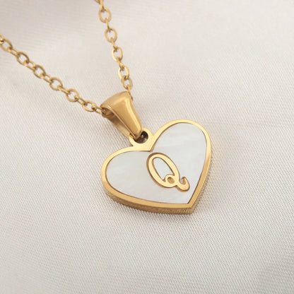 Gold-plated heart necklace with white shell pendant showing letter personalisation option