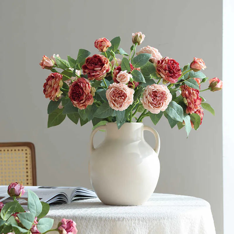 Artificial rose silk flower with baked edge detailing in beige, champagne, green, brown, autumn purple, or gradually pink for wedding decor, photography props, and home styling, a 3-head emulational floral arrangement centrepiece.