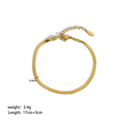Elegant stainless steel bracelet with a sleek geometric design, gold-plated finish, and unisex style suitable for any occasion.