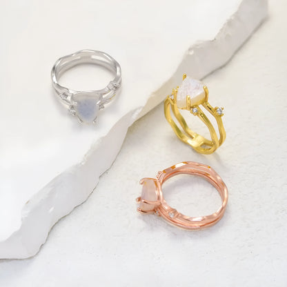 S925 sterling silver ring with an irregular triangular bezel holding a genuine cabochon moonstone, on a model's finger.