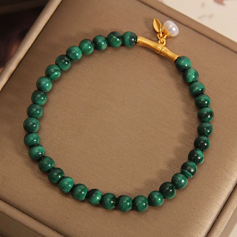 Close-up of a women's adjustable white crystal bracelet featuring a high-rise lucky bamboo design on a wrist.