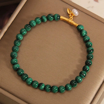 Close-up of a women's adjustable white crystal bracelet featuring a high-rise lucky bamboo design on a wrist.