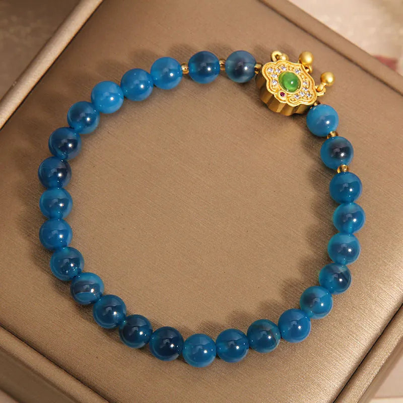 Blue sugar heart agate safety lock pendant on a women's crystal bracelet with alloy inlay and rhinestones.