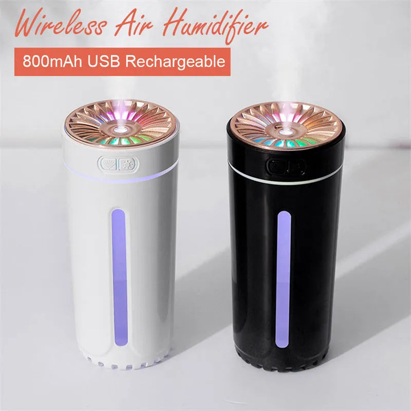 Black portable humidifier with LED lights beside car cup holder showing mist output