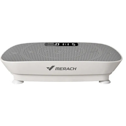 Grey portable vibration plate on a wooden floor, showing its slim 16cm profile and textured platform surface.