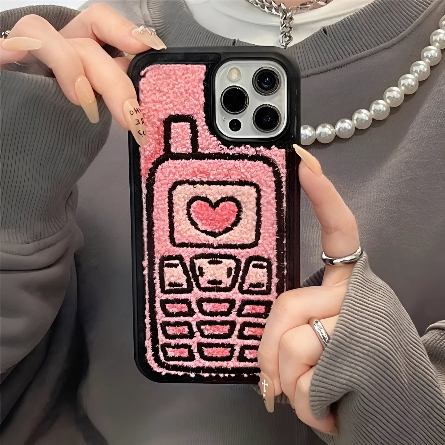 Pink iPhone back cover case with embroidered towel texture design for iPhone models X through 15 Pro Max.