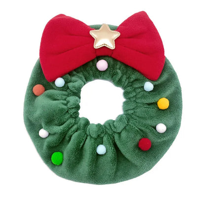 Red bow-knot Christmas pet scarf with colourful fuzzy balls on a dog, showing floral pattern and adjustable fit.
