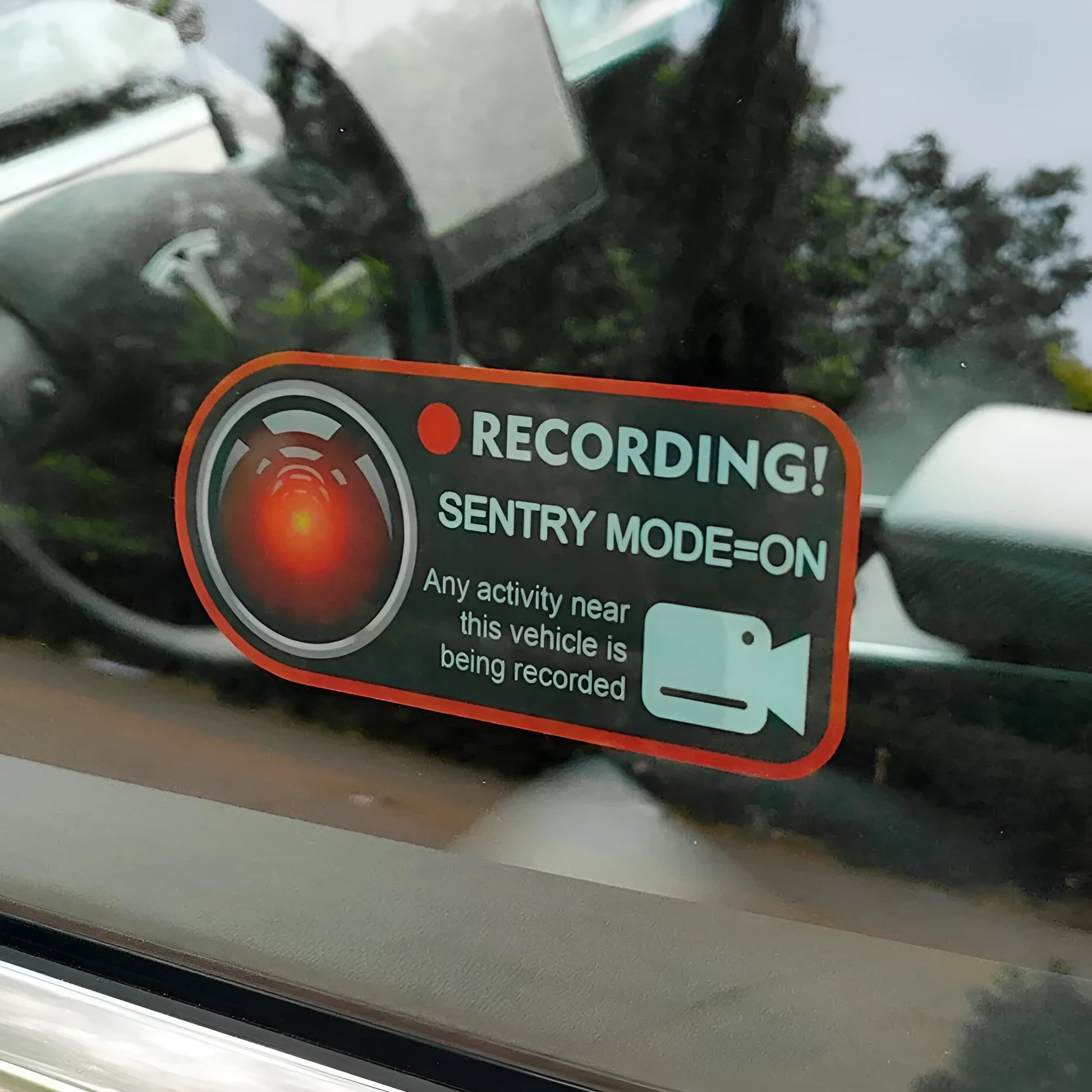 Pair of rectangular 11x5cm Tesla Sentry Mode warning stickers with English text on clear electrostatic backing.