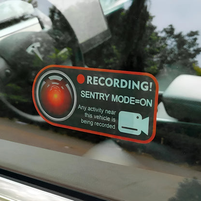 Pair of rectangular 11x5cm Tesla Sentry Mode warning stickers with English text on clear electrostatic backing.