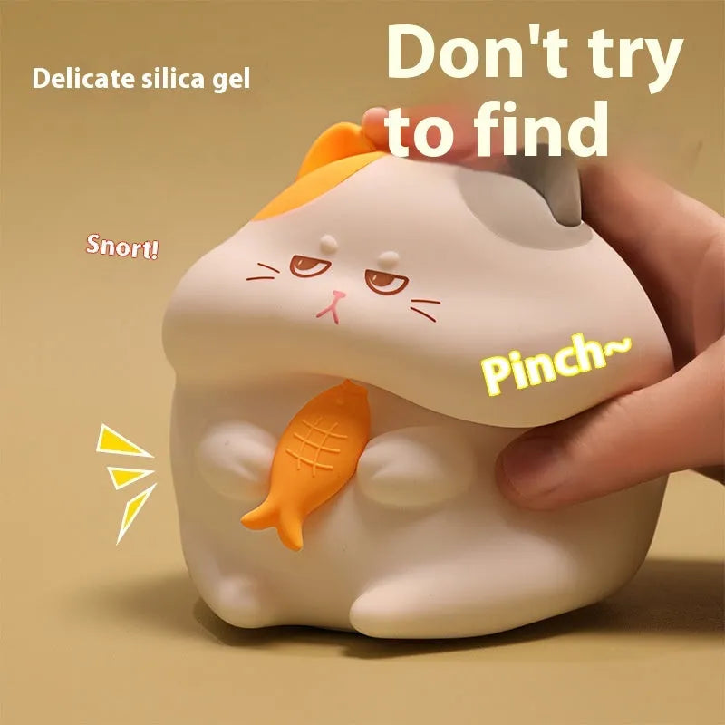 Yellow cartoon Greedy Cat desktop night light with plug, shown on a wooden desk.