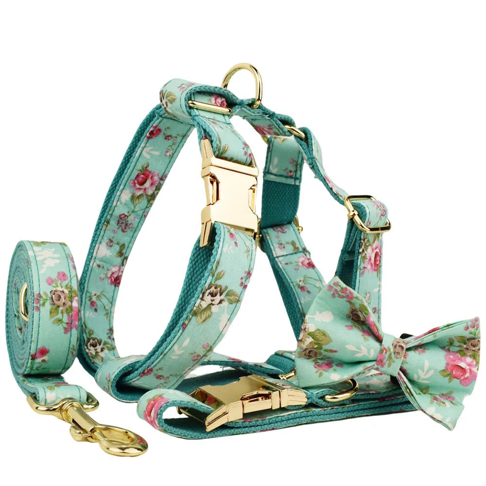Rose and green cloth dog collar set with detachable bow, matching leash, and vest