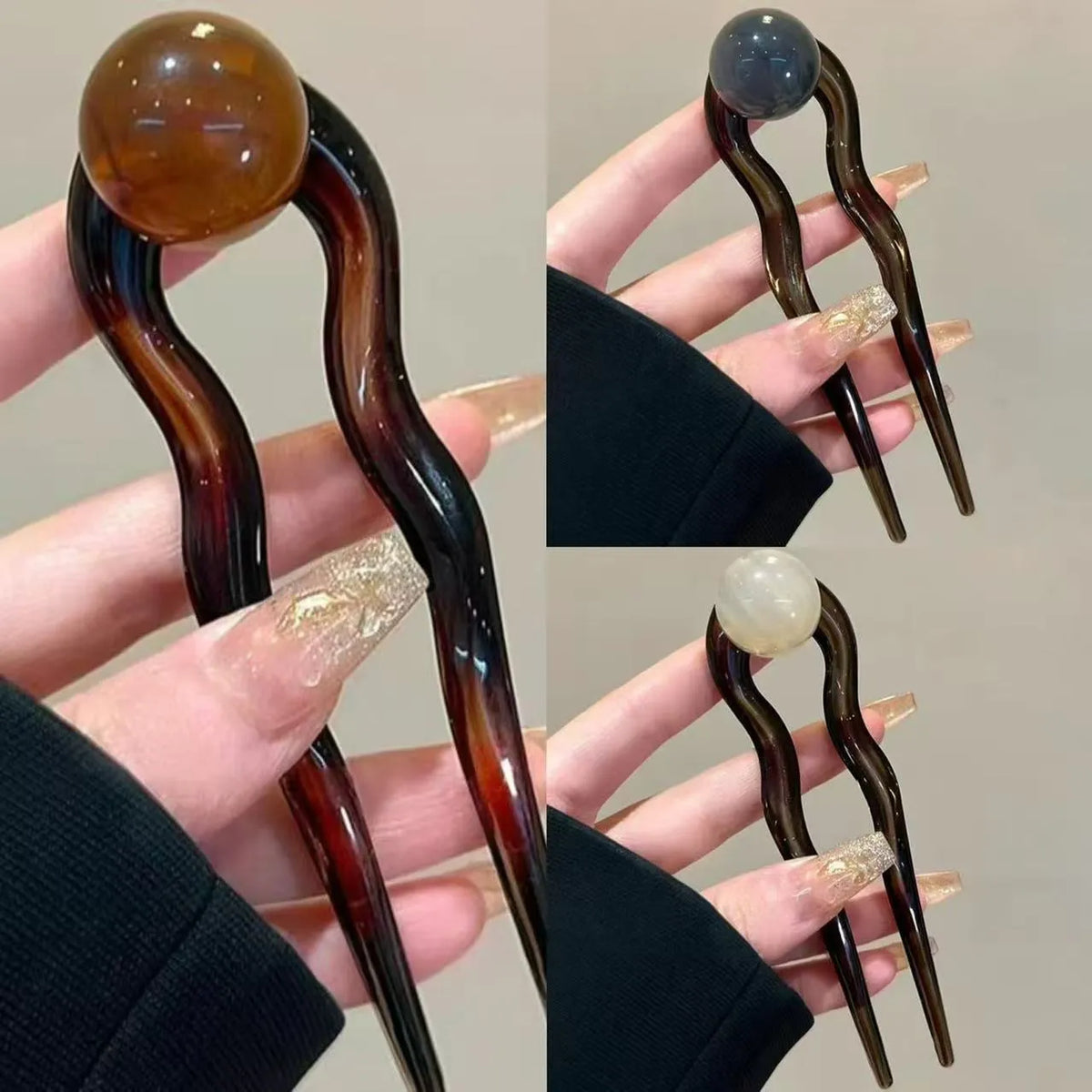 A set of U-shaped acrylic hair barrettes with a simple ball decoration in beige, caramel, and dark grey colours.