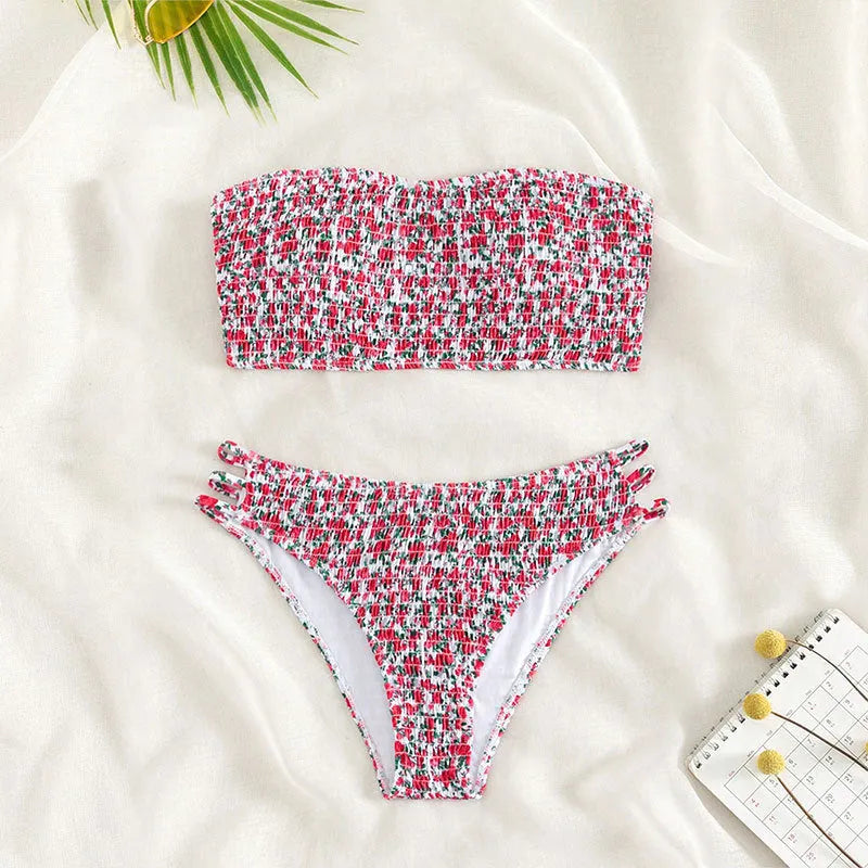 Women's strapless floral swimsuit with high-waist briefs and split back in green flower pattern.