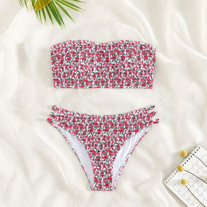 Women's strapless floral swimsuit with high-waist briefs and split back in green flower pattern.