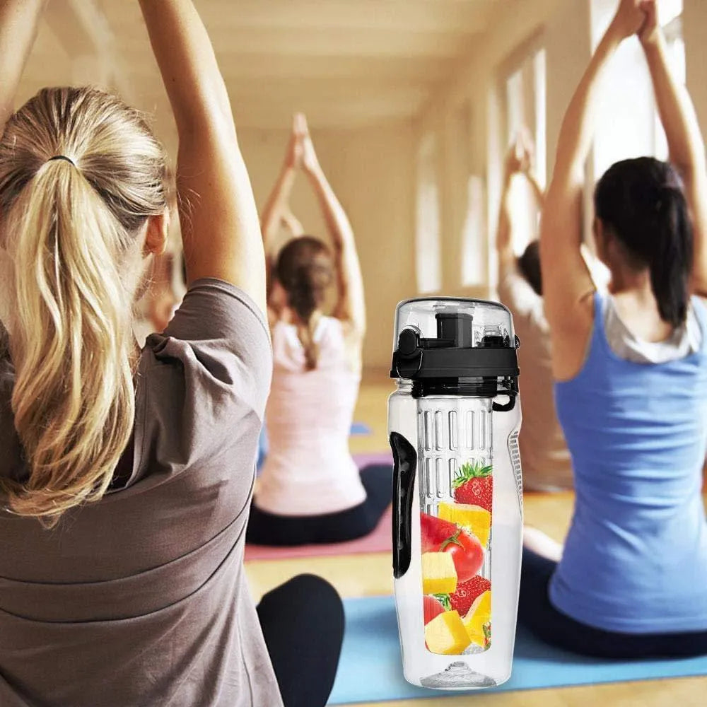 32oz clear Tritan plastic fruit infuser water bottle with a separate fruit cup and leakproof lid.