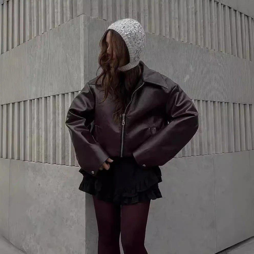 A stylish faux leather jacket with a zipper closure and lapel, available in burgundy and black colors.