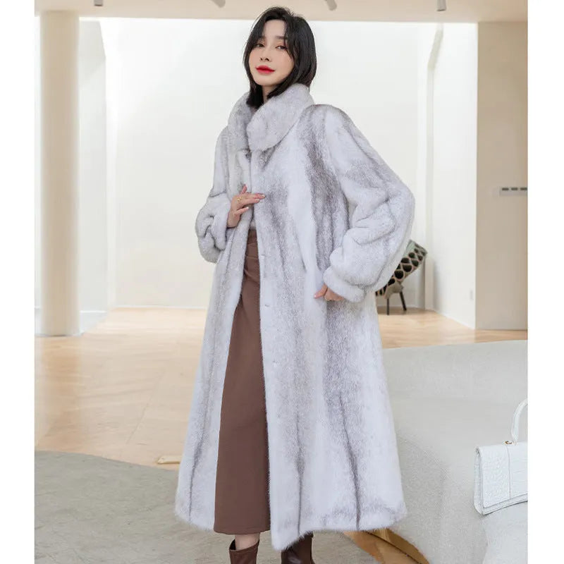 White faux fur women's winter coat with stand-up collar on a hanger