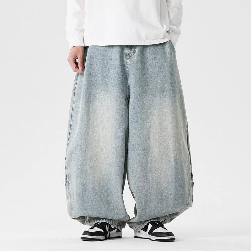 Men's plus-size light blue wide-leg baggy jeans on a neutral background.