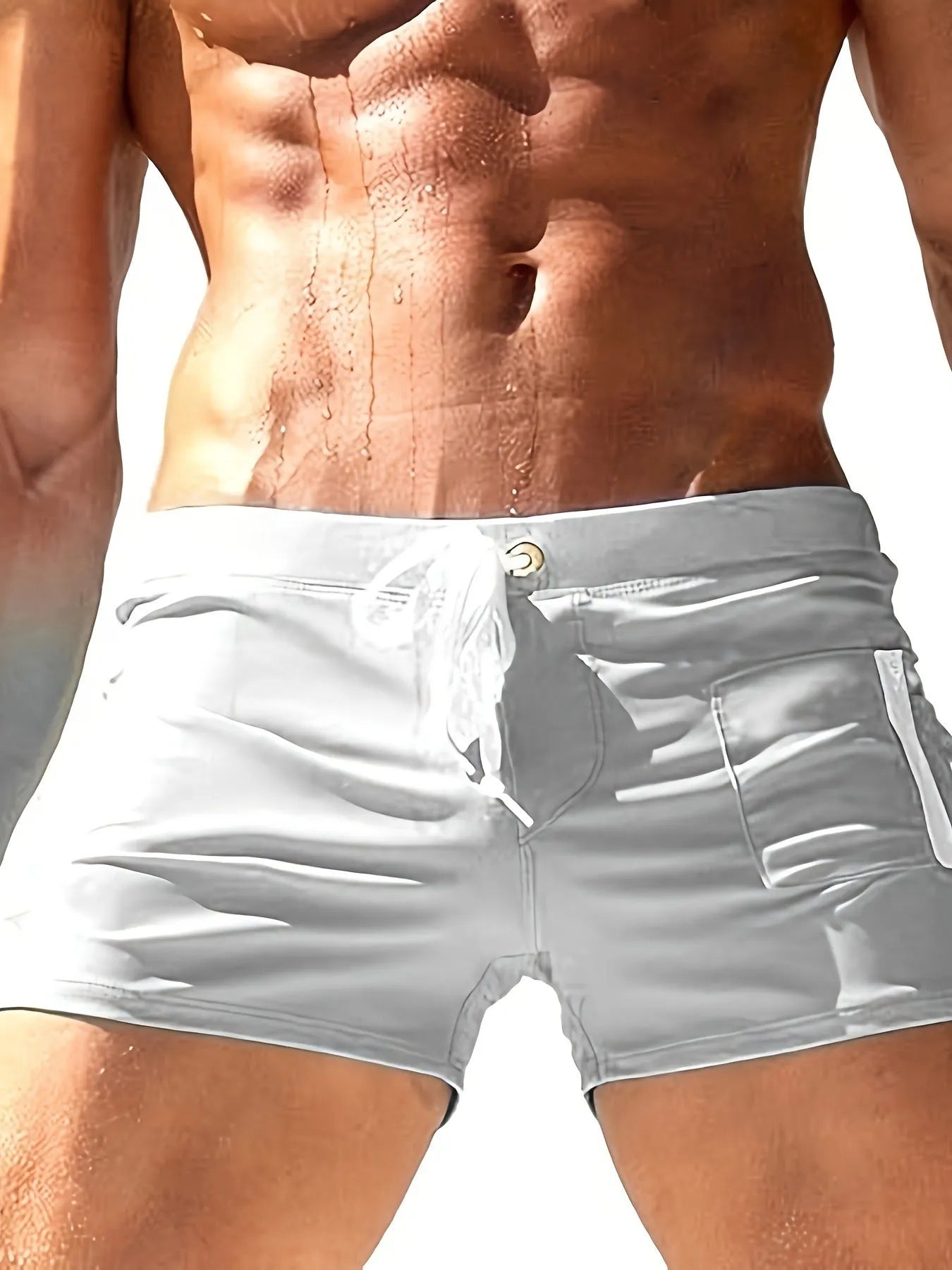 Men's black high-waisted swimming trunks with a lace-up front closure, shown on a model.