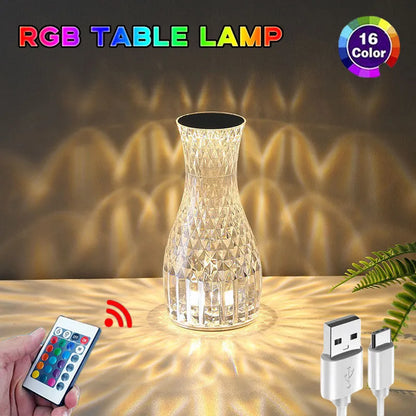 Vase-shaped crystal table lamp with remote control on a bedside table, showing diamond-like glow and USB charging port.