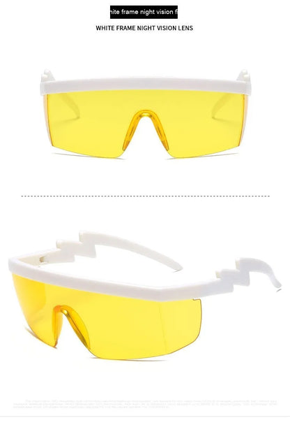 Black one-piece cycling sunglasses with blue polycarbonate lenses and lightning leg temples on a grey background.