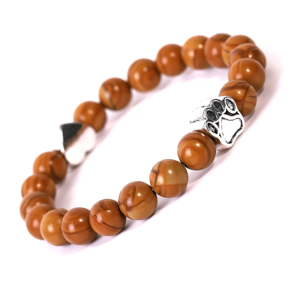 Tiger's eye stone bracelet with dog paw and Indian agate beaded designs on a wrist.
