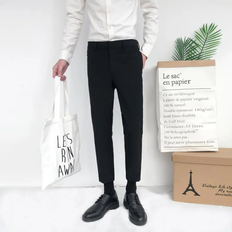 Man wearing black slim straight-leg loose fit cotton trousers with a drawstring waist