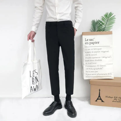 Man wearing black slim straight-leg loose fit cotton trousers with a drawstring waist